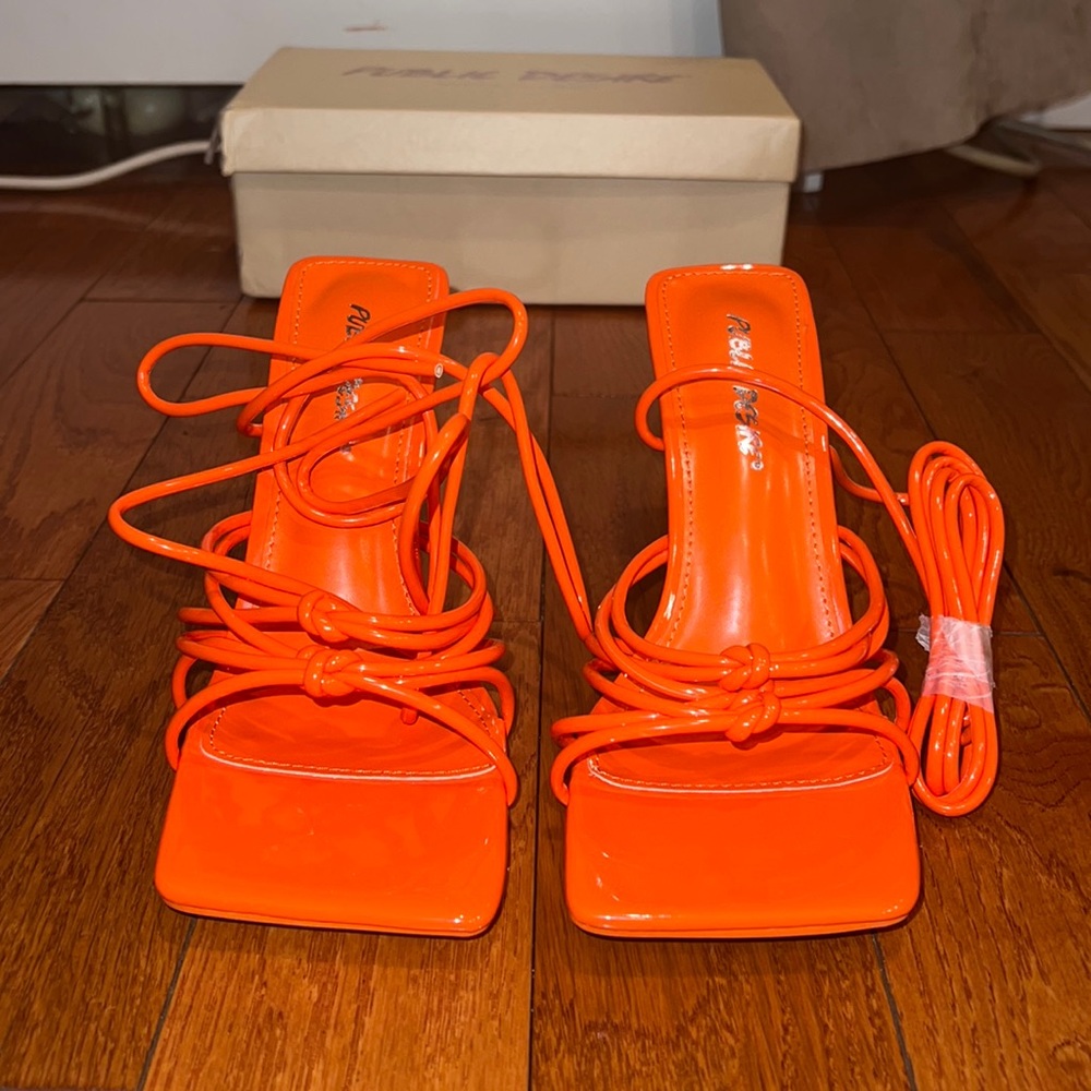 Orange patent leather strappy heels. Never worn.